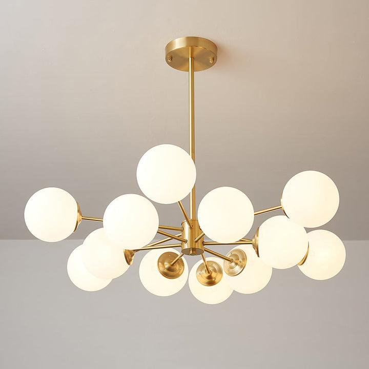 This 12-Light Tired Brass Sputnik Chandelier adds a mid-century modern feel to any room, with brass metal and opal glass shades for a unique yet timeless look. Its milky glass shades evenly distribute light to create bright and cozy illumination perfect for kitchen and dining room lighting.