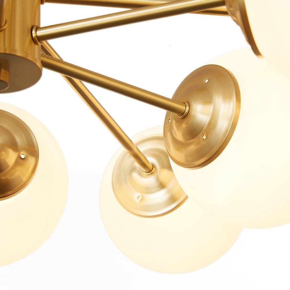 This 12-Light Tired Brass Sputnik Chandelier adds a mid-century modern feel to any room, with brass metal and opal glass shades for a unique yet timeless look. Its milky glass shades evenly distribute light to create bright and cozy illumination perfect for kitchen and dining room lighting.