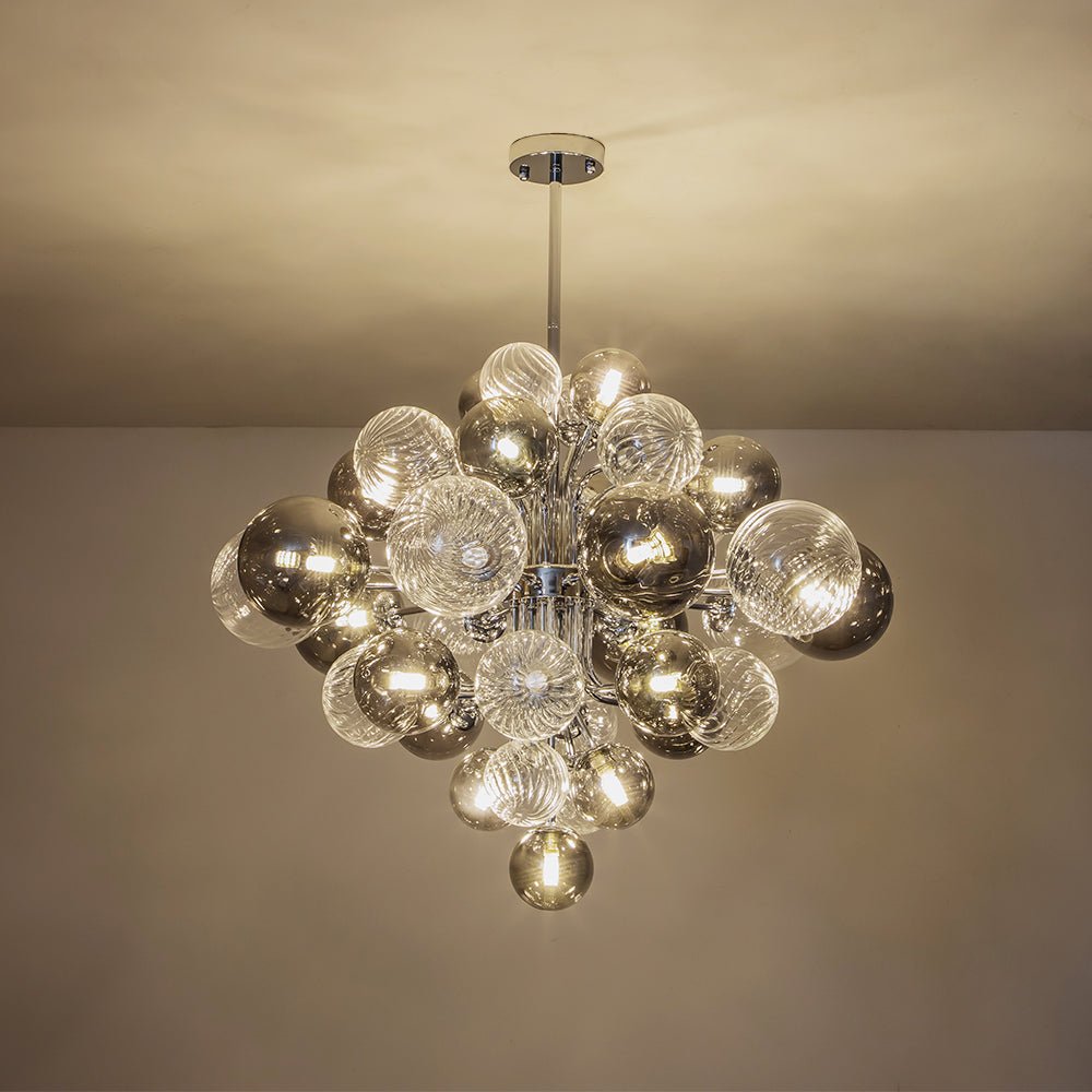 Let your living space shine with elegance and modernity with this 18-Light Chrome Bubble Sputnik Chandelier. Featuring a stunning light capable of being dimmed, this chandelier features a mix of clear and smoke glass globes to provide the perfect touch to any decor. Transform any room from the living room to foyer with a beautiful centerpiece.