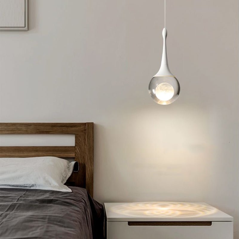 Light up your bedroom with our stunning 1-Light Mini Teardrop Glass Pendant Light! The stunning crystal glass shade houses a beautiful moon sphere, adding a touch of sophisticated elegance to any space. With an integrated 5-watt LED, and 3000K soft warm light, this bedside pendant lamp is sure to create the perfect ambiance. Create an awe-inspiring scene with this stunning pendant light!