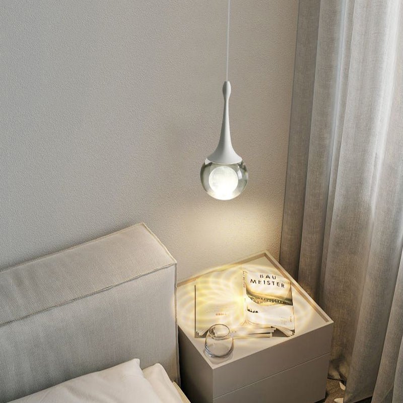 Light up your bedroom with our stunning 1-Light Mini Teardrop Glass Pendant Light! The stunning crystal glass shade houses a beautiful moon sphere, adding a touch of sophisticated elegance to any space. With an integrated 5-watt LED, and 3000K soft warm light, this bedside pendant lamp is sure to create the perfect ambiance. Create an awe-inspiring scene with this stunning pendant light!