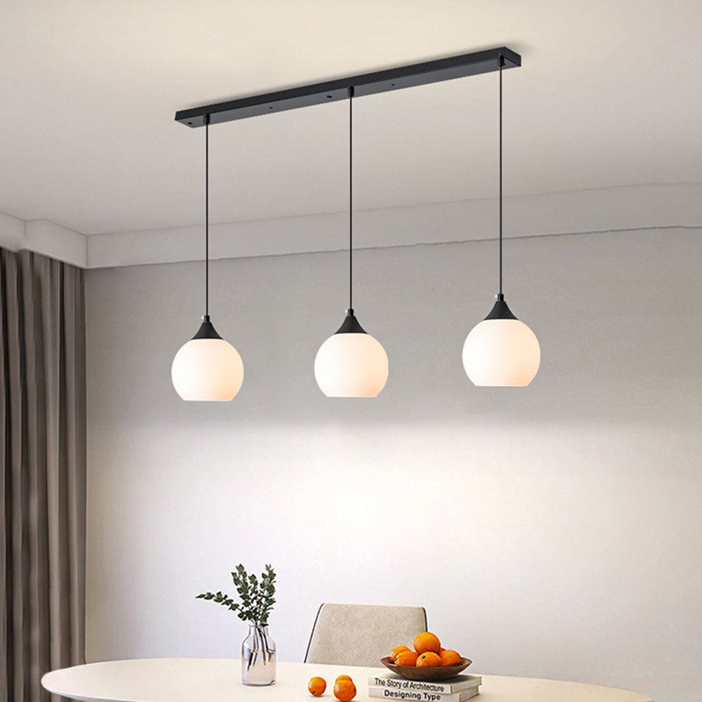 Make a stylish statement in your kitchen with the 3-Light Linear Pendant with Opal Globe Glass Shade. Featuring a sleek black metal frame with three elegant milky glass globes, this modern-looking linear pendant light will provide beautiful illumination above kitchen islands or counters. Create a shining, inviting atmosphere that will leave your guests in awe!