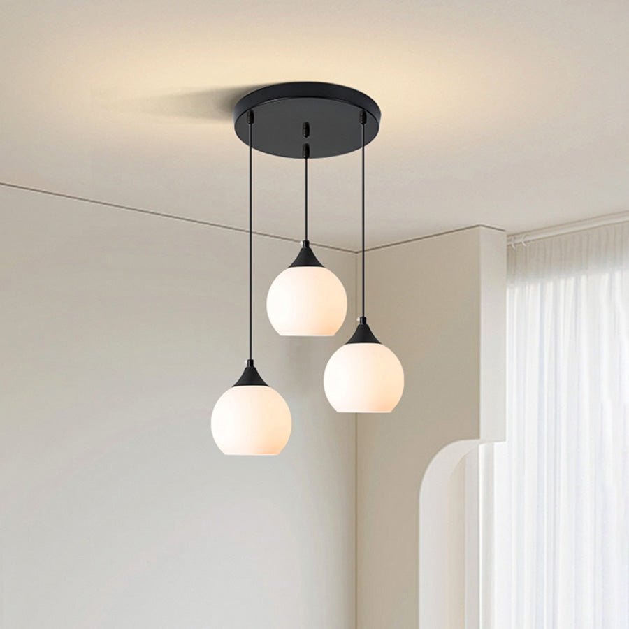 Adorn your kitchen island or dining room with this modern 3-light pendant. The round canopy and milky glass shades evoke an air of sophistication, while the black metal finish creates a sleek, contemporary look. Illuminate your space with this stylish and functional light fixture!