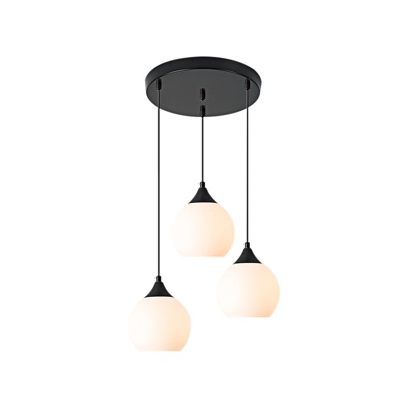 Adorn your kitchen island or dining room with this modern 3-light pendant. The round canopy and milky glass shades evoke an air of sophistication, while the black metal finish creates a sleek, contemporary look. Illuminate your space with this stylish and functional light fixture!