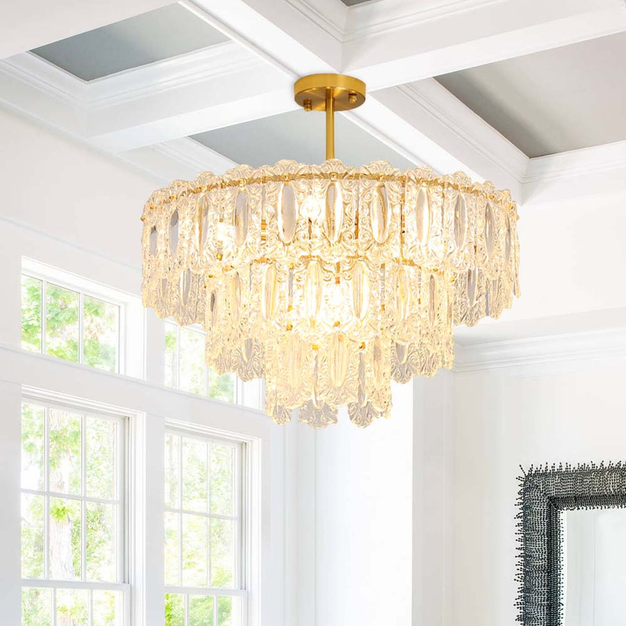 Bring light and shimmering elegance to any room with this modern tiered chandelier. Boasting 56 crystal glass panels and a warm brushed brass finish, this 9-light fixture is perfect for adding a luxurious look to any bedroom, living room, foyer, or entryway. Comes with two size rods for customizable hanging heights.