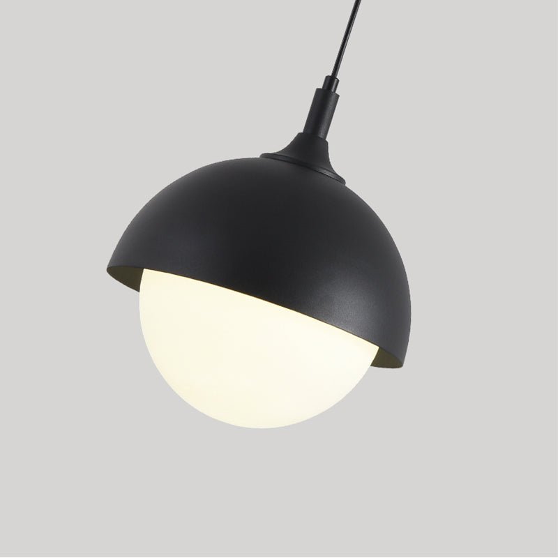 Light up any space with the Nordic Modern 1-Light Globe Pendant Light. This stylish metal dome pendant light features a dome shade holder and an opal glass diffuser, emitting a soft warm light perfect for any bedside, dining room, or kitchen island. With a modern black or modern white finish, this pendant light is sure to add a touch of modern elegance to your home.