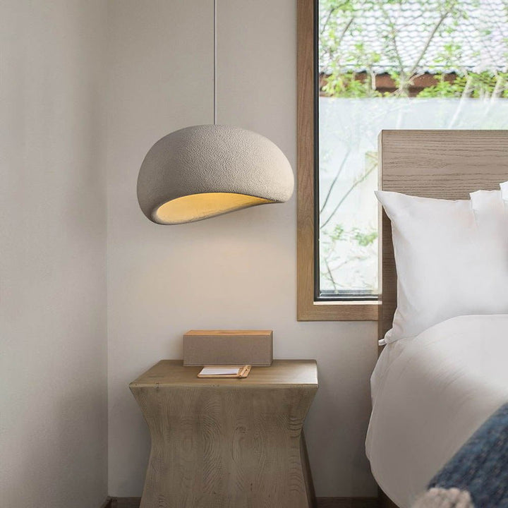 Bring an exclusive touch of style to your home with this sleek 1-Light Textured Ceramic Dome Pendant Light. The dome shade, dotted with handcrafted concrete texture, creates a sophisticated nordic modern design that will complement any bedroom, dining room, or kitchen island. Elevate the atmosphere of your space with this luxurious piece.