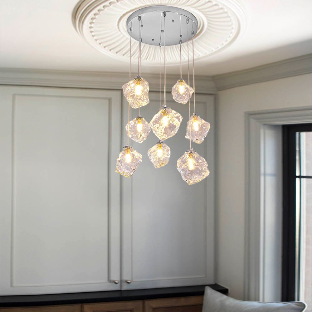 Light up your home with style: the Round Ice Glass Staircase Chandelier in Chrome. Its ice cube glass shade casts a warm, cozy atmosphere, perfect for creating a modern stylish welcoming ambience in the open staircase or entryway. Accentuate high ceilings or long staircases with this stunning chandelier, and watch as your home shines like never before!