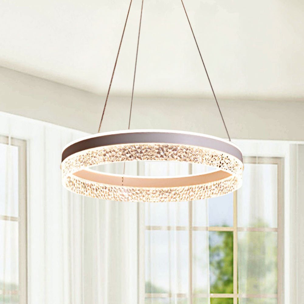 Make a statement with this modern 19.7" Wide LED Ring Chandelier. The diamond acrylic diffuser creates a stunning effect and the tunable white technology featuring 3 color modes will give your space the perfect ambiance. Choose between warm 3000K (soft white), clean crisp 4000K (bright white) or bright 6000K (daylight) -- all in one chandelier! Transform your home with this sleek, stylish chandelier in your choice of white, black, or gold finishes.